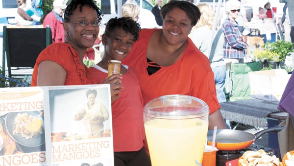 At last year’s Smithfield Farmers’ Market, the ladies from Simply Panache serve up their Mango! Mango! preserves. The market will kick-off its 2013 season this Saturday.