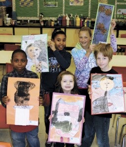 Nansemond Parkway Elementary School will hold a student art show in the gym on Tuesday. In the classroom of art teacher Qua Cummings on Friday, Morgan Green, Sydney Corey, Ronald Mountcastle, Everly Vaskey and Colin Carlson hold up their exhibition pieces.
