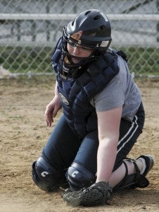 Suffolk Christian Academy's McKayla West practices at the catcher position at Peanut Park on Friday in preparation for the coming softball season.