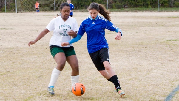 Eighth-grade midfielder Victoria Twisdale of Suffolk Christian Academy tries to get past the defensive pressure from Virginia Beach Friends School on Tuesday evening at the SYAA Fields. Twisdale scored during the Lady Knights' 5-3 win.