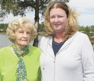 At left, Steven Wheeler fries hushpuppies at the Davis Lakes and Campground 30th anniversary celebration on Saturday. Above, Davis Lakes owner and operator Denise Thomas stands with her mother, Helen Davis, whose husband Art started the campground as a pet project.