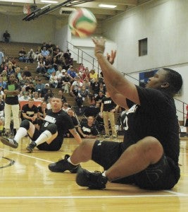 Army Sgt. Monica Southall, an automated logistics specialist assigned to the Community-Based Warrior Transition Unit in Virginia and a 2012 Warrior Games gold medalist in sitting volleyball, sets up a shot for her teammates during the 2013 Warrior Games sitting volleyball preliminaries on Monday.