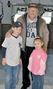 Connor and Abby Herrington, both Oakland Elementary School students, pose with their great-grandfather, "Brother Beans," during a trip to Yankee Stadium earlier this month.