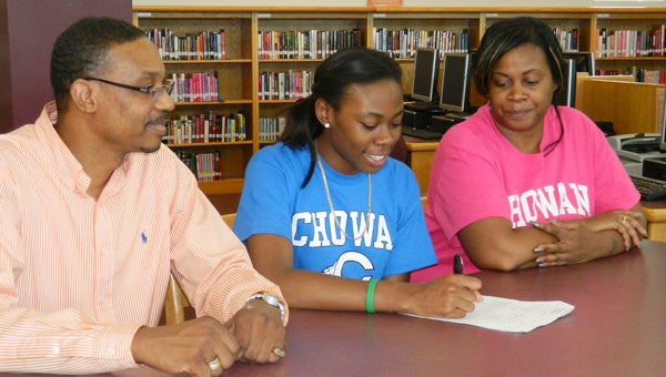 Chantel Roberts of King’s Fork committed to attend and play basketball for Chowan University during a Wednesday signing ceremony at King’s Fork High School. Her parents, Curtis and Lisa Roberts, look on and look forward to seeing her play at the next level.