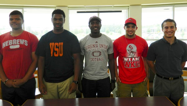 King's Fork's Alex Holloway, Clarence Burrus, DeShawn Johnson, James Hibbs and Danny Gromkoski publicly committed to play college football during a ceremony on Thursday at King's Fork High School.
