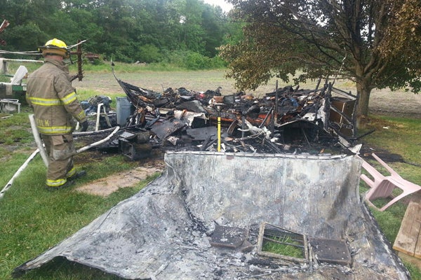 A camper trailer was destroyed and a man injured in a fire on Thursday in Whaleyville.