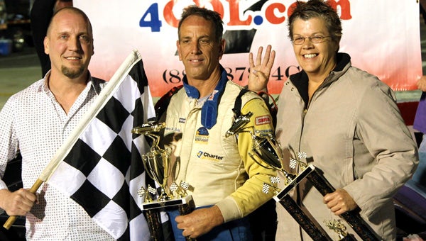 Robbie Babb, center, celebrates his fourth win of the season with his wife and a race sponsor during Saturday’s racing action in the NASCAR Whelen All-American Series at Langley Speedway. He leads the points standings in the Modified class.