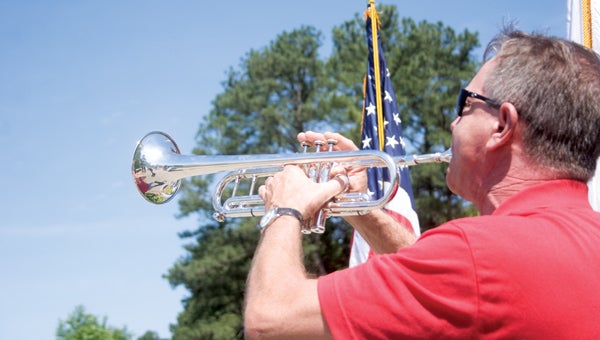 R.E. Spears III/Suffolk News-Herald Michael Eberhardt blows “Taps” on his bugle near the end of a Memorial Day ceremony on Monday at the Albert G. Horton Jr. Memorial Veterans Cemetery in Suffolk. Hundreds of people turned out under sunny skies for the annual ceremony.