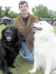 Rob New and his dogs Jackie, left, and Jasmine, right, were among thousands of human and canine attendees at the fifth annual Mutt Strut on Sunday at Sleepy Hole Park.