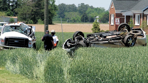 Rescue personnel investigate a deadly wreck along Pruden Boulevard Tuesday afternoon. One man was pronounced dead on scene, and two other victims were transported to Sentara Norfolk General Hospital.