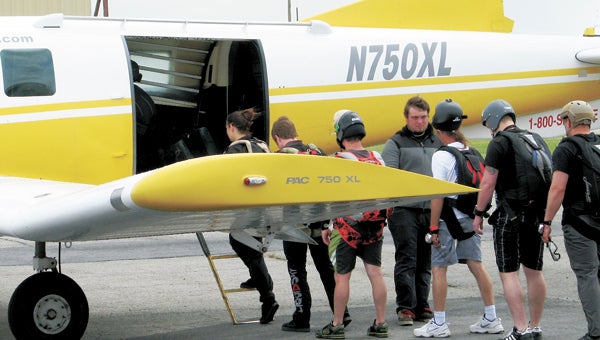 A group of hopeful wounded warriors heads to a plane at Skydive Suffolk Saturday afternoon during the Jumping for a Purpose. They returned in the plane, however, after a brief separation in the clouds closed back up and prevented skydiving activity.
