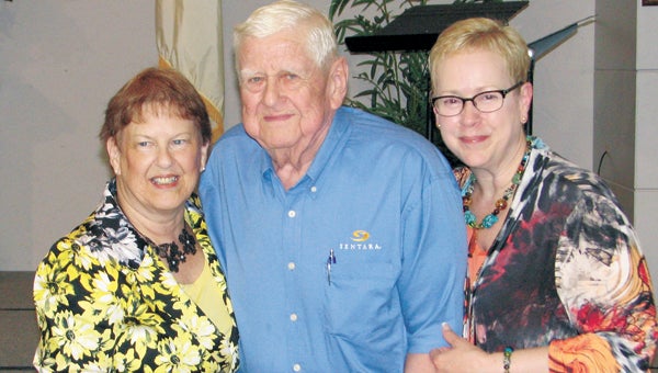 Otha Rountree, center, receives an award for volunteering more than 11,500 hours at Sentara Obici Hospital during his lifetime. He is joined by hospital auxiliary president Bonnie Langer, left, and hospital vice president for patient care services Phyllis Stoneburner.