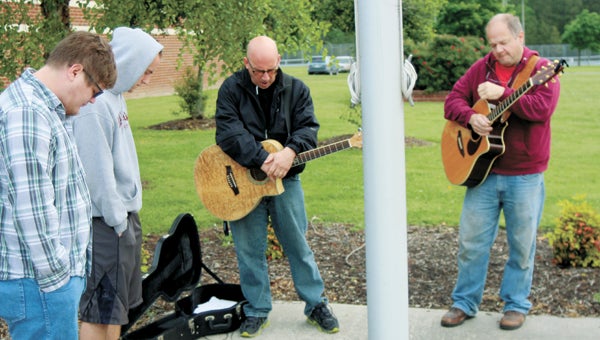 During National Day of Prayer Thursday, Chris Whiting, Dylan Teager, Win Anderson and Mark Holland, of Family Harvest Church, exercise their free speech rights to bring prayer and songs of praise to Lakeland High School.