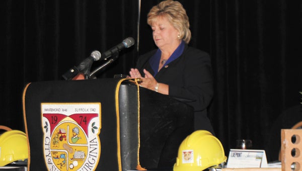 Mayor Linda T. Johnson delivers her State of the City speech at the Hilton Garden Inn on East Constance Road on Tuesday. The hardhats and bricks on the table symbolize the "Blueprint for Success" theme.