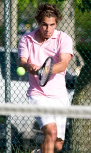 Nansemond-Suffolk Academy junior Jackson DeMello competes against visiting Norfolk Christian High School on Thursday. The Saints ultimately fell 5-4 as a team against the Ambassadors. NSA wore pink on its Senior Day to promote breast cancer awareness.