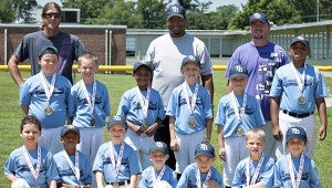 The Rays (5- to 9-year-olds) of Bennett’s Creek Little League’s Coach Pitch division wear the medals commemorating their 6-4 win over the Mets in the spring season-ending tournament championship game. Pictured are, front row, from left, Grant Nolan, Kamren Robinson, Jakob Beauchamp, Gavin Shelburne, Jackson Gardner, J.T. Bowins and Leah Bernini; middle row, from left:  Connor Christian, Alex Miniard, Aden Judge, Lance Everette, Hunter Hutchinson and Bryan Papillion Jr.; back row, from left: coach Derrick Gardner, coach Sean Judge and coach David Christian. (Beansprout Photography by Sarah Murphy)