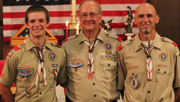 Blake O. Bullock, left, stands with Scoutmaster Robert Baker, center, and father Kevin Bullock following a ceremony in which the younger Bullock received his Eagle Scout Badge from Troop 1 in Suffolk. Bullock became the 136th Eagle Scout from his troop, which years ago had awarded Eagle badges to his father and his uncle.