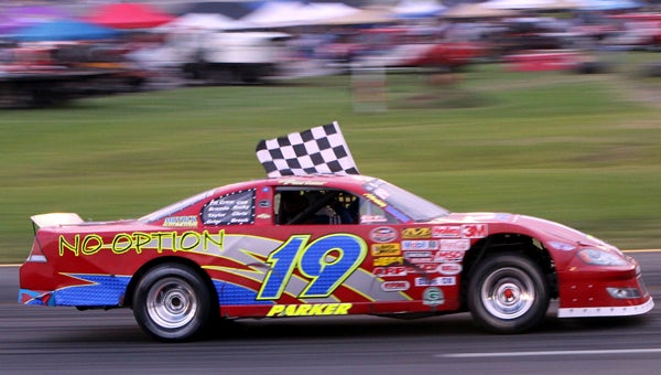Robbie Parker takes a victory lap with the checkered flag after winning the 40-lap Grand Stock Class event, last Saturday at Langley Speedway. (Bill Carr/MotorSports Photo News Service)
