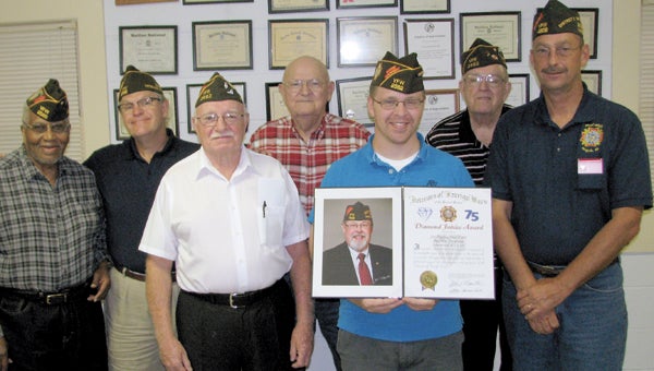 Members of VFW Post 2582 show off the proclamation from VFW Commander-in-Chief John Hamilton in honor of their 75th anniversary at their meeting on Thursday night. From left are George Martin, Denis Confer, Bob Grady, Billy Twine, Kenny Wiseman, Ben Plewes and District 2 Commander Eric Mallett.