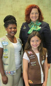 Suffolk Girl Scout Cadette Kristen Boone, left, and Girl Scout Brownie Claire Askew, center, pose with Girl Scouts of the Colonial Coast CEO Tracy Keller after being recognized at a special luncheon for selling more than 1,000 boxes of cookies each during the 2013 Girl Scout Cookie Program. 