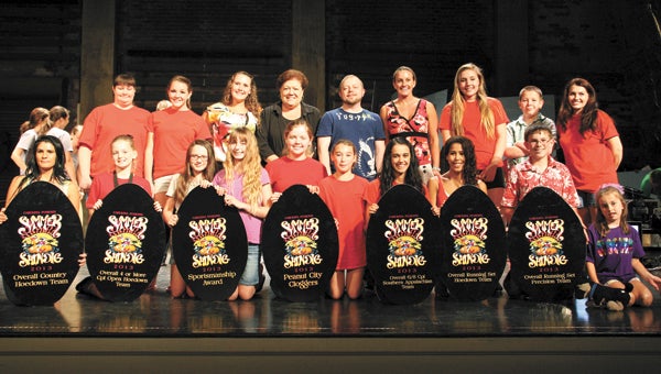 The Peanut City Cloggers show off their multiple awards from a recent competition. The group is competition in a clogging competition this weekend as well. Top row from left, Teresa Davis, Payton Kerlee, Karley Barnes, Donna Riley, Bob Greene, Joann Bricker, Jordan West, Jakob Randall and Judi Lester. Bottom row from left, Lindsay Skeen, Olivia Morris, Hannah Baines, Katie Timmins, Mackenzie West, Brooke Hayden, Leia Dotson, Samantha Thomason, Harrison Storms and Reilly Price.