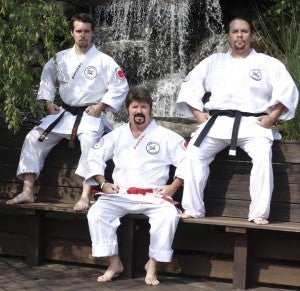 Kyoshi Jeff Bateman, front, and his students-turned-instructors Nathan Luckado, left, and Brandon Kolipano were recently inducted into the World Karate Union Hall of Fame. Bateman, who had previously been inducted under the title Black Belt Instructor of the Year, was receiving the latest induction by way of the Golden Lifetime Achievement Award of Honor. Luckado and Kolipano were each received into the Hall with the title of Associate Instructor of the Year.