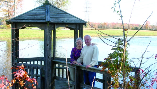 FIle Photo Linda and Tom Ashe, directors of The Well Retreat Center just across the city line from Suffolk, show off the retreat’s lake in 2010. The Catholic Diocese of Richmond announced this weekend The Well will close this fall because it is being underused.
