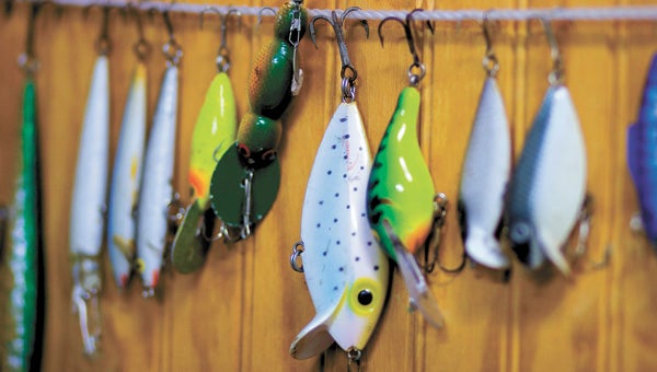 Employees of Culpepper Boats at the Cohoon-Meade Fishing Station rescue lures that have wound up in the trees and bushes alongside the two lakes and give them new lives as decorations inside the bait shop.