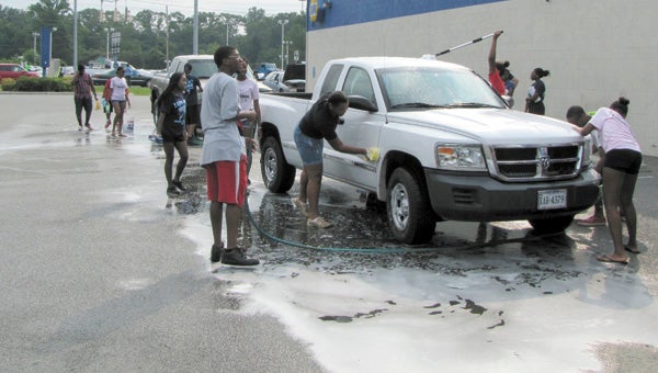 The Lakeland High School band booster club is planning two fundraising car washes for the “Quiet Storm.” Here, band members get down to work during a previous car wash.