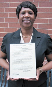 Denise Jackson holds the proclamation she received in a ceremony at Suffolk Juvenile and Domestic Relations Court on Monday.