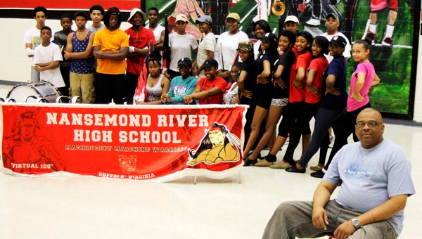 Members of Nansemond River High School’s marching band smile for the camera with band director, Edward J. Woodis. The Suffolk Band Alumni Association is raising money to help the band operate and attend events.