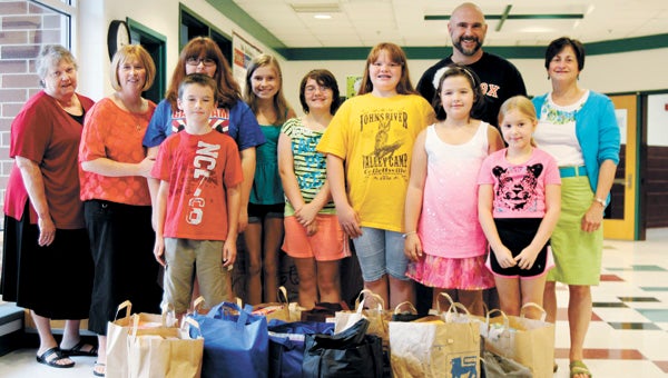 Bonnie Dinges, Kirsten Wise, Zoie Wise, Alex Shearin, Emma Shearin, Kathleen Stump, Abagayle Nelms, Lauren Howell, Jason Stump, Peyton Wise and Rev. Janet Boyd Weidler, congregants of Oakland Christian United Church of Christ, delivered back-to-school supplies to Oakland Elementary School Tuesday.