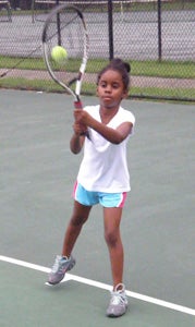 Six-year-old Ashiya Bland takes lessons from Janice Henderson on Wednesday evening at the Howard Mast Tennis Complex. Henderson hopes that Saturday’s Howard Mast Tennis Day will attract many more interested players, young and old, to Suffolk’s tennis program.