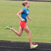 Suffolk’s Betsy Pollard, 12, runs in the AAU Area 4 Junior Olympic National Qualifier at Nansemond River High School last weekend. Never having run the 3000-meter race before, she won it, and also placed fourth in the 1500-meter run to qualify for the AAU Junior Olympic Games in both events.