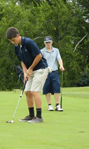 Lakeland High School senior Dalton Hoffman putts the ball as junior Blake Harris looks on during Monday's match against Western Branch High School at Sleepy Hole Golf Course. Hoffman and Harris are expected to lead the Cavaliers this year as the team's No. 1 and No. 2 players, respectively.