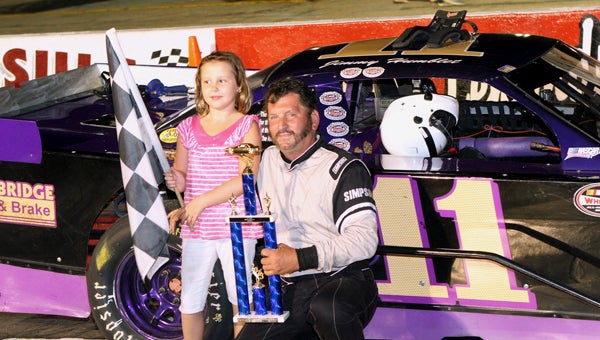 Following one of his two wins Saturday in the twin 30-lap Modifieds Class of the NASCAR Whelen All-American Series program at Langley Speedway, Jimmy Humblet receives a trophy from the daughter of one of the sponsor parents. (Bill Carr/MotorSports Photo News Service)