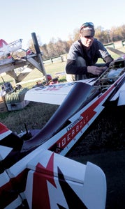 A radio-control plane pilot inspects his aircraft at a Hampton Roads RC Club event in 2011. The club will have an event this Saturday to raise money for the Wounded Warrior Project.