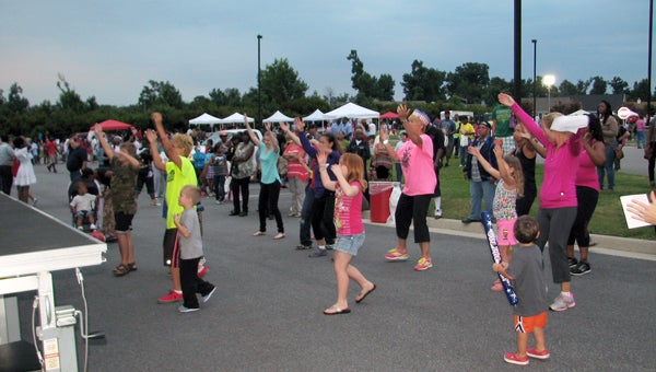 Partygoers take part in Zumba at the National Night Out celebration at Sentara Obici Hospital, which combined the Applewood Farms, Burnett’s Mill and Hillpoint neighborhoods.