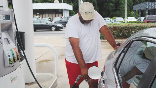 Dwight Dodson gases up at Southern gas station on North Main Street on Monday.