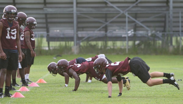 King's Fork High School football players hit the ground and pop up during a defensive pursuit drill that was part of conditioning at the first official day of practice for the fall season on Monday.