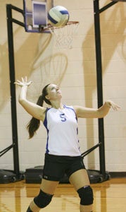 Senior setter Hannah Fagan serves during the second game of Tuesday's match against visiting Victory Christian School. The Lady Knights lost this season opener, but Fagan will help lead an experienced group of young players this year, featuring eight varsity returners.