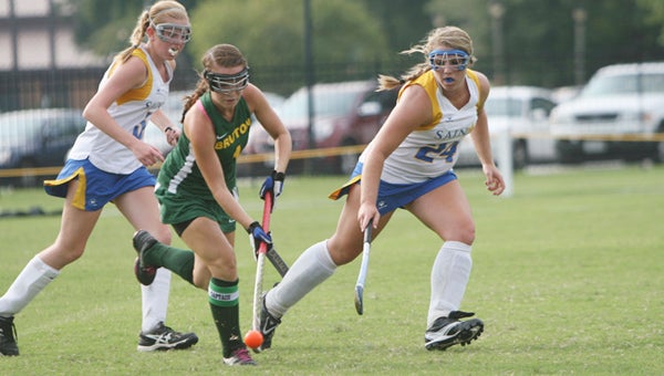 Sophomore forward Emily Mason, left, and sophomore mid-fielder Brooklyne Carr defend against a Bruton High School player during Tuesday’s season opener. NSA will be counting on every player on the roster to step up since the team has only 12 members in a sport requiring 11 on-field players.