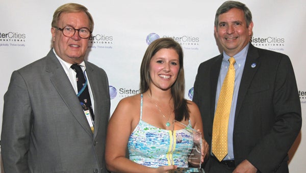Taylor Hart Odom, center, accepts the Suffolk Sister Cities’ Innovation Award in Youth and Education at last month’s conference in San Antonio, Texas, from Bill Boerum, left, Sister Cities International vice chairman, and Tom Lisk, chairman.