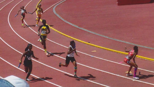 Suffolk’s Jazmine Tilmon, center, runs her leg of the 4x100-meter relay on the AAU Virginia Elite Team at the AAU Junior Olympic Games in Michigan last week. (Photo submitted by Tanya Tilmon)