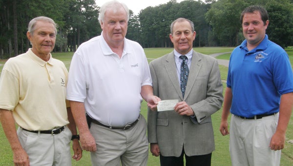 Sandy Winslow, president of the Suffolk Recreational and Charitable Association, holds a check for $1,000 with Suffolk Christian Academy board chairman Mark McGahee, on the right. The check will be donated to the SCA golf team. From left are SCA head golf coach Mike Bigony, SRCA president Sandy Winslow, SCA board chairman Mark McGahee and SCA athletics director Steven Milner.