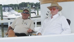 Capt. David Rollins, right, and Capt. Sonny Hines, left, converse about the oyster business on the Samuel M. Bailey.