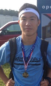 Fifteen-year-old Kevin Tohak wears a gold medal he earned after winning in the 19-and-under age group at the recent Run for the Homefront 5K in Virginia Beach. It is the latest step in Tohak's rapid development as a runner, an athletic endeavor he started less than a year ago.