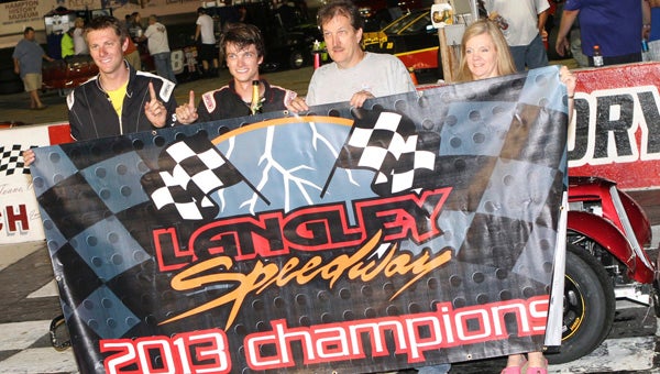 Spencer Saunders, second from left, driver of the Saunders Family Racing Team car, celebrates with family and crew after his win in the second of the Twin 25s in the INEX Legends Series at the Langley Speedway on Saturday. The win gave Spencer a three-point lead and the 2013 track championship as the Legends closed out its 2013 season. (Bill Carr/MotorSports Photo News Service)