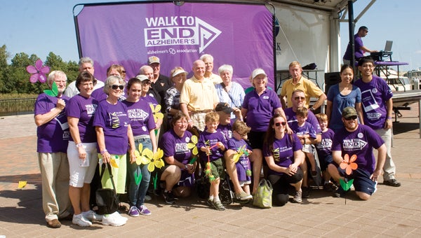 Members of the Suffolk Exchange Club pose for photos in front of the Alzheimer’s Association banner at the Walk to End Alzheimer’s on Saturday at Constant’s Wharf Park. The club was the second-place fundraiser, coming in behind Smithfield Foods’ walkers. (R.E. Spears III/Suffolk News-Herald)