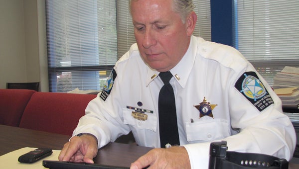 Monitoring: Lt. Michael Whalen uses an iPad to monitor offenders who participate in the Western Tidewater Regional Jail’s electronic monitoring program. (Tracy Agnew/Suffolk News-Herald)